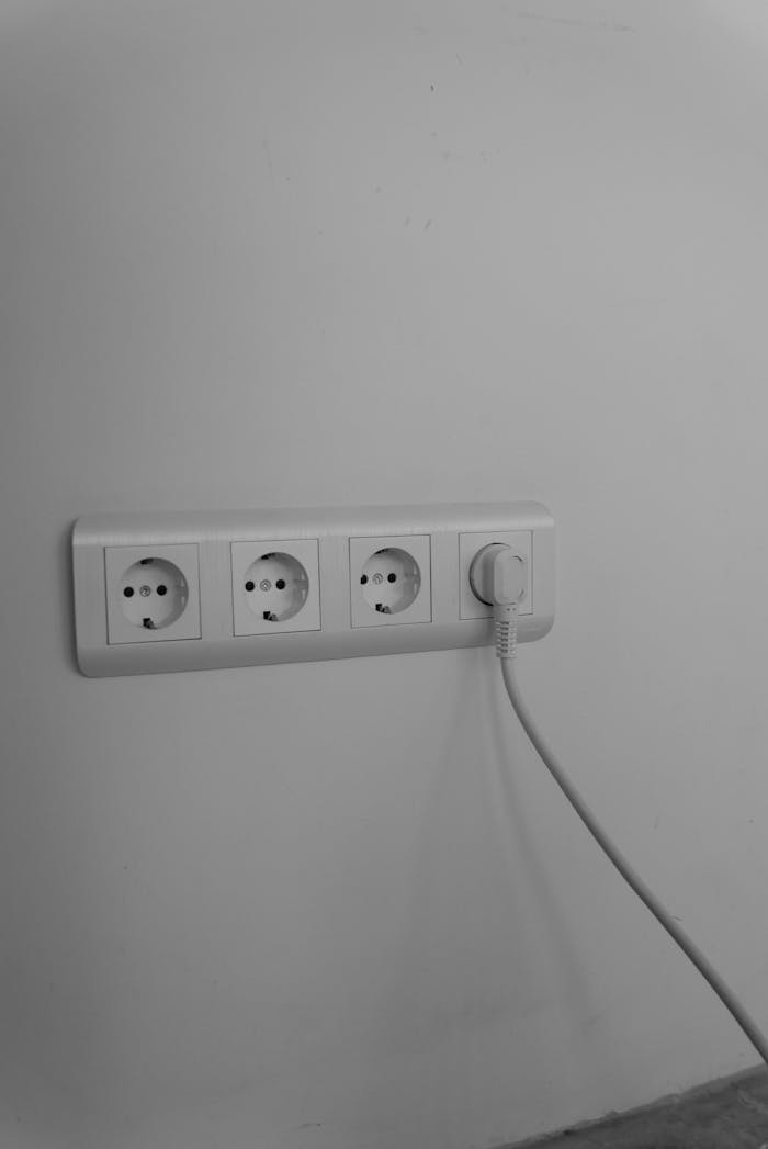 journey A clean and minimalist wall socket with a single plug connected, emphasizing modern interior design.
